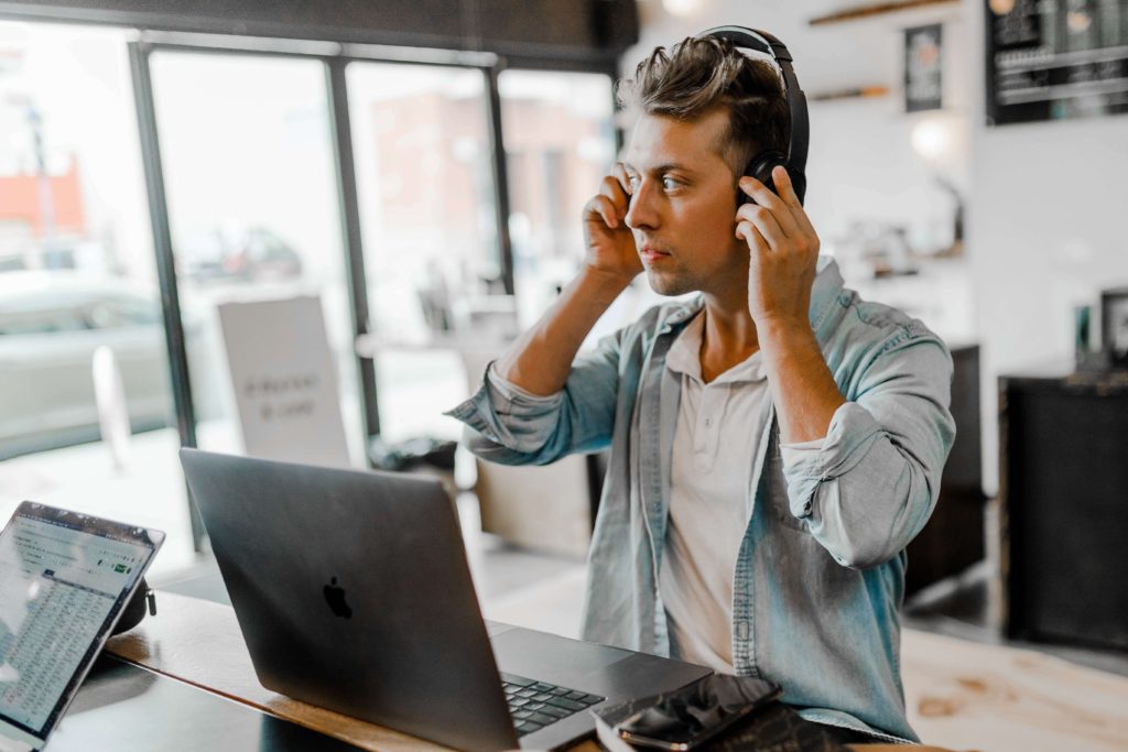 A remote employee putting on headphones to join a meeting.