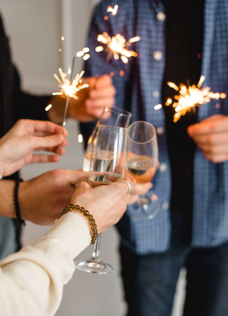 People celebrating with sparklers and a special cheers.