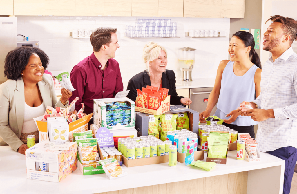 Large group of employees enjoying snacks and each other's company.