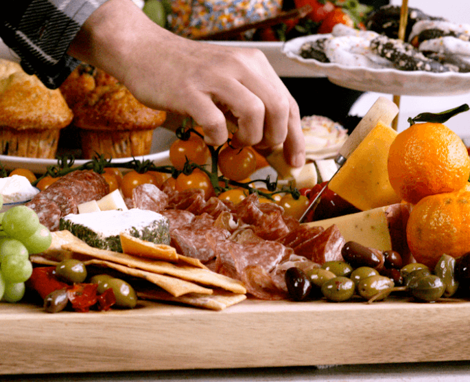 A Dept. of Superior Dishes charcuterie board, with a large variety of meats, cheeses, fruits, crackers, and more.