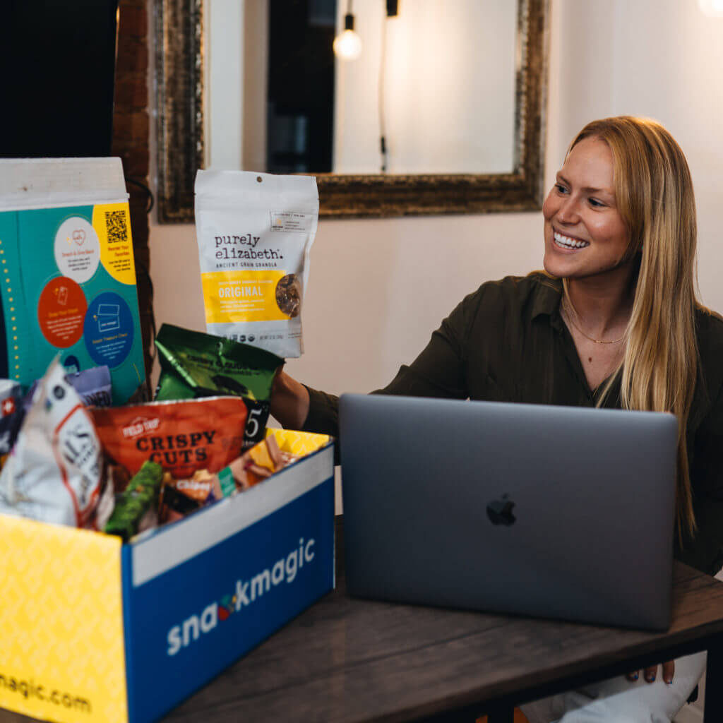 A virtual employee taking a break to enjoy a large SnackMagic box full of treats. 