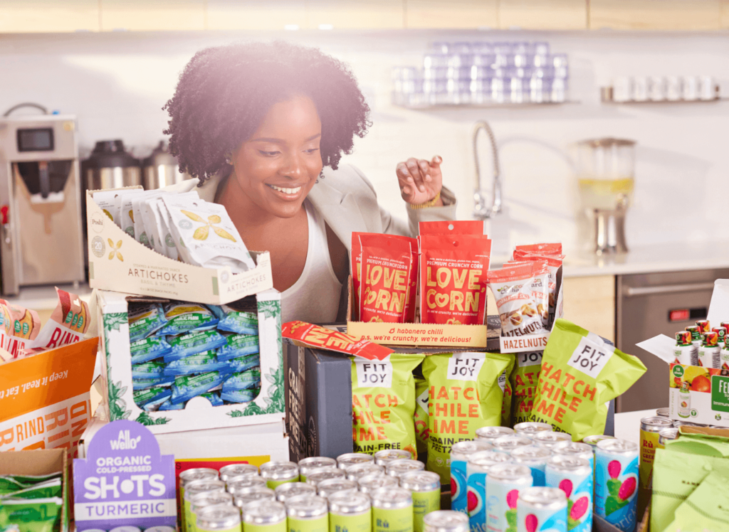 A young woman checking out the new shipments of snacks from Snack Magic in the work break room.