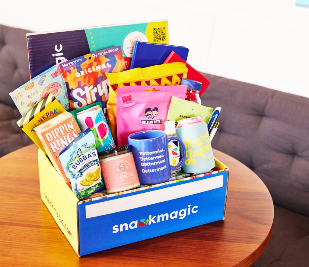 A huge offering of snacks and treats in a Snack Magic box on a conference room table. 