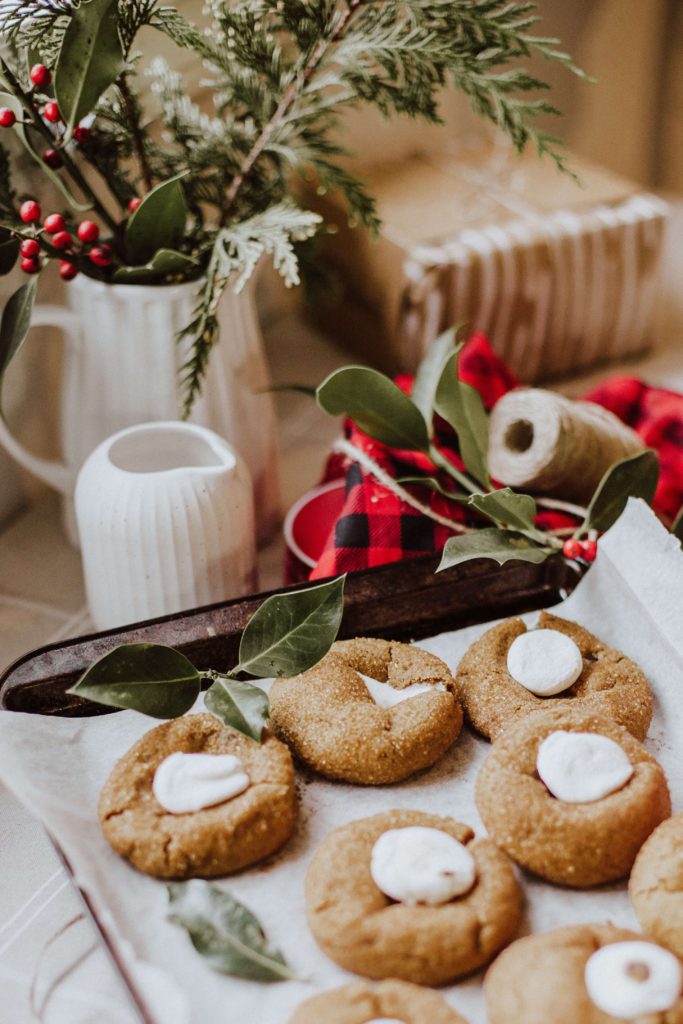 Homemade holiday cookies laid out with other gifting supplies.